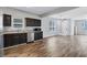 Spacious kitchen and dining area with stainless steel appliances, dark cabinets, and hardwood floors perfect for cooking and entertaining at 217 Odyssey Turn, Conyers, GA 30012