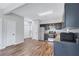 Well-lit kitchen features stainless steel appliances, ample counter space, and modern dark cabinets at 217 Odyssey Turn, Conyers, GA 30012