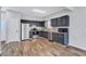 Kitchen featuring a stainless steel refrigerator, dark cabinets, and wood-look flooring at 217 Odyssey Turn, Conyers, GA 30012