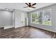 Inviting living room with hardwood floors, large windows, and a ceiling fan, creating a comfortable and airy ambiance at 217 Odyssey Turn, Conyers, GA 30012
