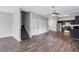 Open-concept living area with wood-look floors leads to a staircase and a modern kitchen at 217 Odyssey Turn, Conyers, GA 30012