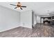Open-concept living room showcasing wood-look floors, neutral paint, and a view into the kitchen at 217 Odyssey Turn, Conyers, GA 30012
