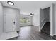 Open concept living space with hardwood floors, a staircase, and plenty of natural light, creating an inviting atmosphere at 217 Odyssey Turn, Conyers, GA 30012