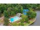 Aerial shot showcasing the pool, clubhouse, and tennis courts nestled amidst lush greenery near the lake at 434 Teal Ct, Roswell, GA 30076