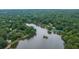 Panoramic aerial view of a serene lake surrounded by lush, dense trees, creating a private, natural environment at 434 Teal Ct, Roswell, GA 30076