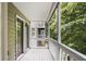 Charming balcony offering serene views of the surrounding lush greenery and multi-level balconies at 434 Teal Ct, Roswell, GA 30076