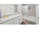 Modern bathroom showcasing granite countertops, a shower with glass doors, and gray tile at 434 Teal Ct, Roswell, GA 30076
