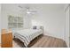 Bright bedroom with ceiling fan, hardwood floors, and a large window with natural light at 434 Teal Ct, Roswell, GA 30076