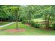 Lush green space with walking paths, mature trees, and water views offers a relaxing outdoor experience at 434 Teal Ct, Roswell, GA 30076