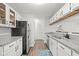 Stylish kitchen with stainless steel appliances, granite countertops, and white cabinetry with bar to living room at 434 Teal Ct, Roswell, GA 30076