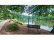 Relaxing lakeside view with a bench, walking path and mature trees at 434 Teal Ct, Roswell, GA 30076