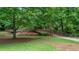 Scenic walking bridge surrounded by lush greenery and a stream offers a serene outdoor experience at 434 Teal Ct, Roswell, GA 30076