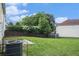 A large backyard featuring a combination of trees, shrubs, and grass at 4438 Parmalee Path, Conley, GA 30288
