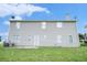 The back of this home features neutral siding and a spacious backyard at 4438 Parmalee Path, Conley, GA 30288