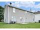 The back of this home features neutral siding and a spacious backyard at 4438 Parmalee Path, Conley, GA 30288