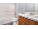 Bathroom with a white shower-tub and a wood vanity at 4438 Parmalee Path, Conley, GA 30288