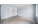 Bedroom with neutral carpet, light blue walls, two closets, and a window at 4438 Parmalee Path, Conley, GA 30288
