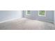 Bedroom with neutral carpet, light blue walls, baseboards, and two windows at 4438 Parmalee Path, Conley, GA 30288