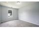 Bedroom with neutral carpet, light gray walls, and a window at 4438 Parmalee Path, Conley, GA 30288