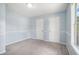 Bedroom with neutral carpet, light blue walls, two closets, and a window at 4438 Parmalee Path, Conley, GA 30288