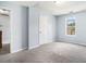 Bedroom with neutral carpet, light blue walls, one closet, and a window at 4438 Parmalee Path, Conley, GA 30288