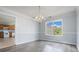 Dining room featuring a hanging chandelier and a large window to let in natural light at 4438 Parmalee Path, Conley, GA 30288