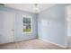 An empty, well-lit room with light blue walls, hardwood floors, and a white door at 4438 Parmalee Path, Conley, GA 30288