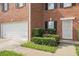 A close-up view showing the brick facade, garage, and entryway of the home at 4438 Parmalee Path, Conley, GA 30288