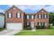 Charming two-story brick home with black shutters and a well-manicured front yard at 4438 Parmalee Path, Conley, GA 30288
