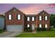 Beautiful brick home with a two-car garage and mature landscaping at 4438 Parmalee Path, Conley, GA 30288