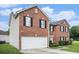 A side view showing the brick and siding exterior, garage, and tidy landscaping of the home at 4438 Parmalee Path, Conley, GA 30288