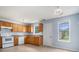 Kitchen featuring white appliances, wooden cabinets and laminate countertops at 4438 Parmalee Path, Conley, GA 30288