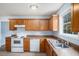 Kitchen featuring white appliances, wooden cabinets and a stainless steel sink at 4438 Parmalee Path, Conley, GA 30288