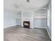 Living room featuring a fireplace, built-in shelves and gray floors at 4438 Parmalee Path, Conley, GA 30288