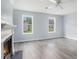 Bright living room features fireplace, ceiling fan, and large windows providing plenty of natural light at 4438 Parmalee Path, Conley, GA 30288