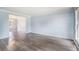 Bright living room features wood look floors and view into another room at 4438 Parmalee Path, Conley, GA 30288