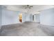 Large main bedroom with carpeted floors, tray ceiling, and view into en suite bathroom at 4438 Parmalee Path, Conley, GA 30288