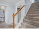 Carpeted staircase with white risers and a wood banister leading to the upper level at 4438 Parmalee Path, Conley, GA 30288