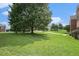 Spacious grassy front yard with a mature shade tree and plenty of room to play at 4438 Parmalee Path, Conley, GA 30288