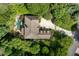 Aerial view of a sprawling property, showcasing a well-maintained lawn, mature trees, and a private pool area at 5284 Vernon Springs Nw Trl, Sandy Springs, GA 30327