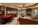 Entertaining basement features stone fireplace, kitchenette bar area, poker table, and comfortable seating at 5284 Vernon Springs Nw Trl, Sandy Springs, GA 30327