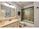 Clean bathroom featuring granite countertops, a large framed mirror, and a tiled shower and tub at 5284 Vernon Springs Nw Trl, Sandy Springs, GA 30327