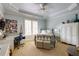 Light blue bedroom with tray ceiling, comfortable bedding, an office space, and plenty of natural light at 5284 Vernon Springs Nw Trl, Sandy Springs, GA 30327