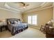 Cozy bedroom features a comfortable bed, neutral decor, a ceiling fan, and a window with plantation shutters at 5284 Vernon Springs Nw Trl, Sandy Springs, GA 30327