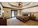 Comfortable bedroom with decorative ceiling, ceiling fan, dresser and walkout to patio at 5284 Vernon Springs Nw Trl, Sandy Springs, GA 30327