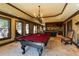 Spacious billiard room with large windows, two pool tables and a kitchenette in the background at 5284 Vernon Springs Nw Trl, Sandy Springs, GA 30327