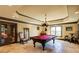 Entertaining billiard room featuring unique chandelier, large windows, and a red felt pool table at 5284 Vernon Springs Nw Trl, Sandy Springs, GA 30327