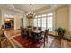 Charming dining room with hardwood floors, bright window, and elegant chandelier and decorative rug at 5284 Vernon Springs Nw Trl, Sandy Springs, GA 30327