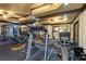 Well-equipped home gym with treadmills, weight machines, and mirrored walls at 5284 Vernon Springs Nw Trl, Sandy Springs, GA 30327