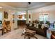 Elegant living room featuring hardwood floors, crown molding, and seamless transition to the kitchen at 5284 Vernon Springs Nw Trl, Sandy Springs, GA 30327